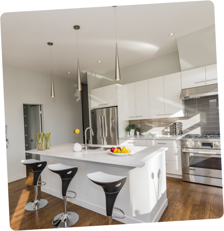 Bright remodeled kitchen with quartz countertops and pendant lighting