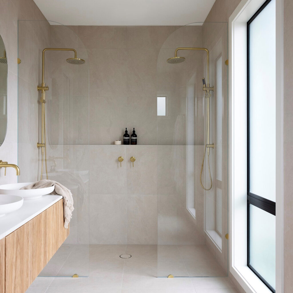 Renovated bathroom with tiled walk-in shower and double vanity